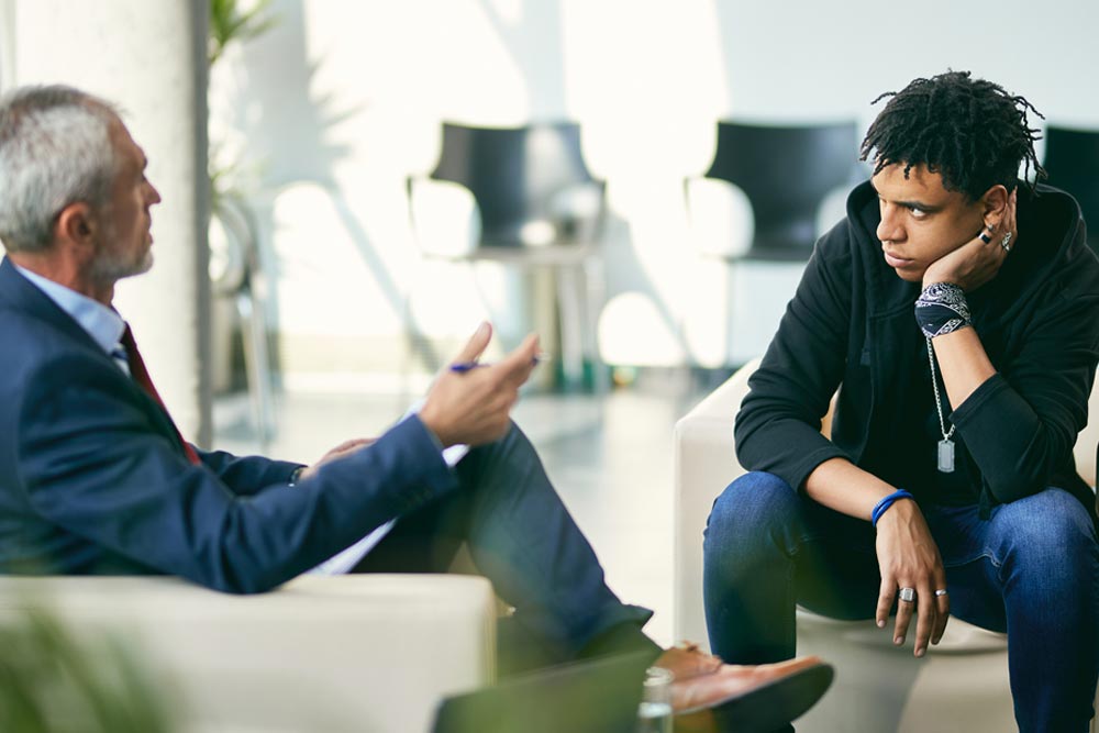 a male client with a psychologist during an outpatient program
