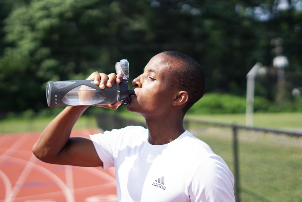 young man drinking plenty of water