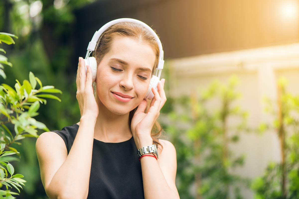 woman listening to music as part of her healing from Mental Health