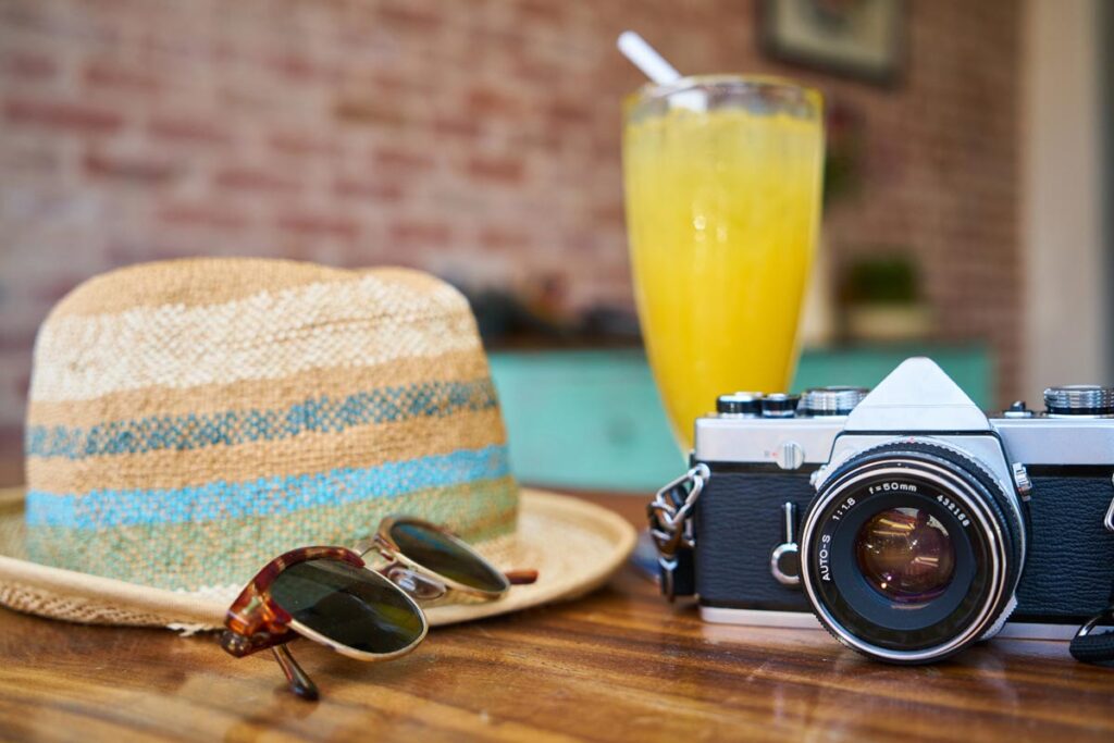 hat, sun glasses, camera and juice summer vacation