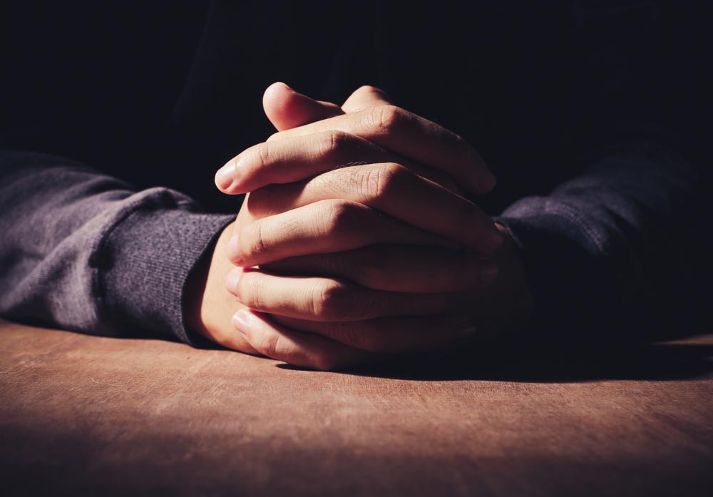 man praying to God to remove his shortcomings