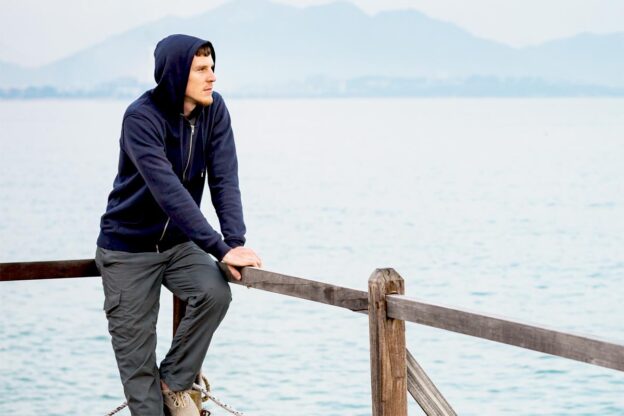 man wearing hoodie thinking about going to inpatient rehab
