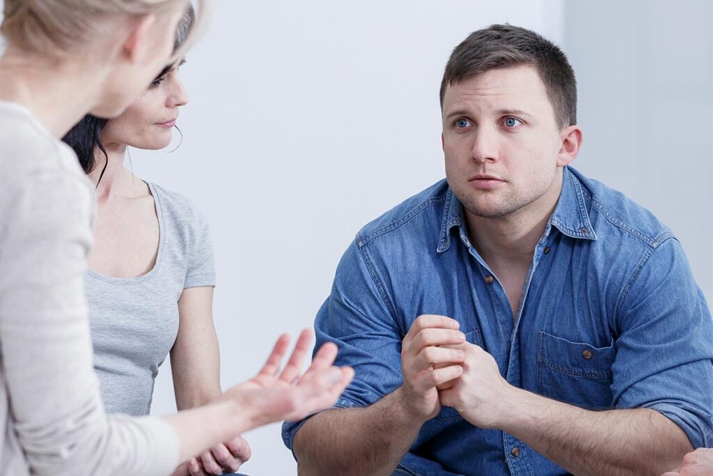 a male client with his wife during an intervention at a rehab center